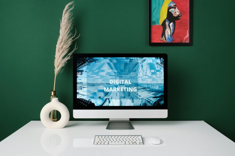 A contemporary office desk with computer screen showcasing digital marketing content.